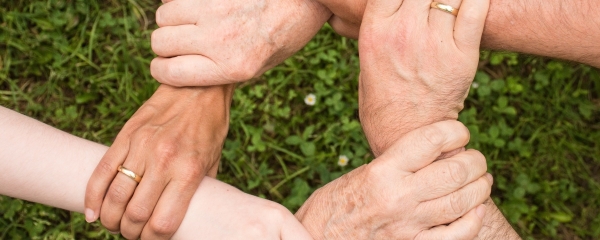 People holding hands to form a loop