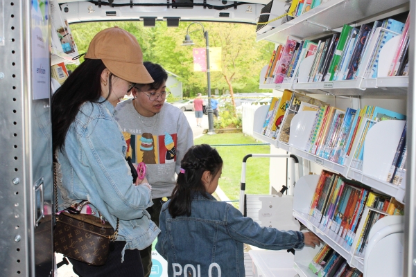 Inside the Mobile Library with a family and staff member