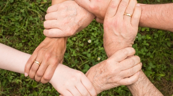 People holding hands to form a loop